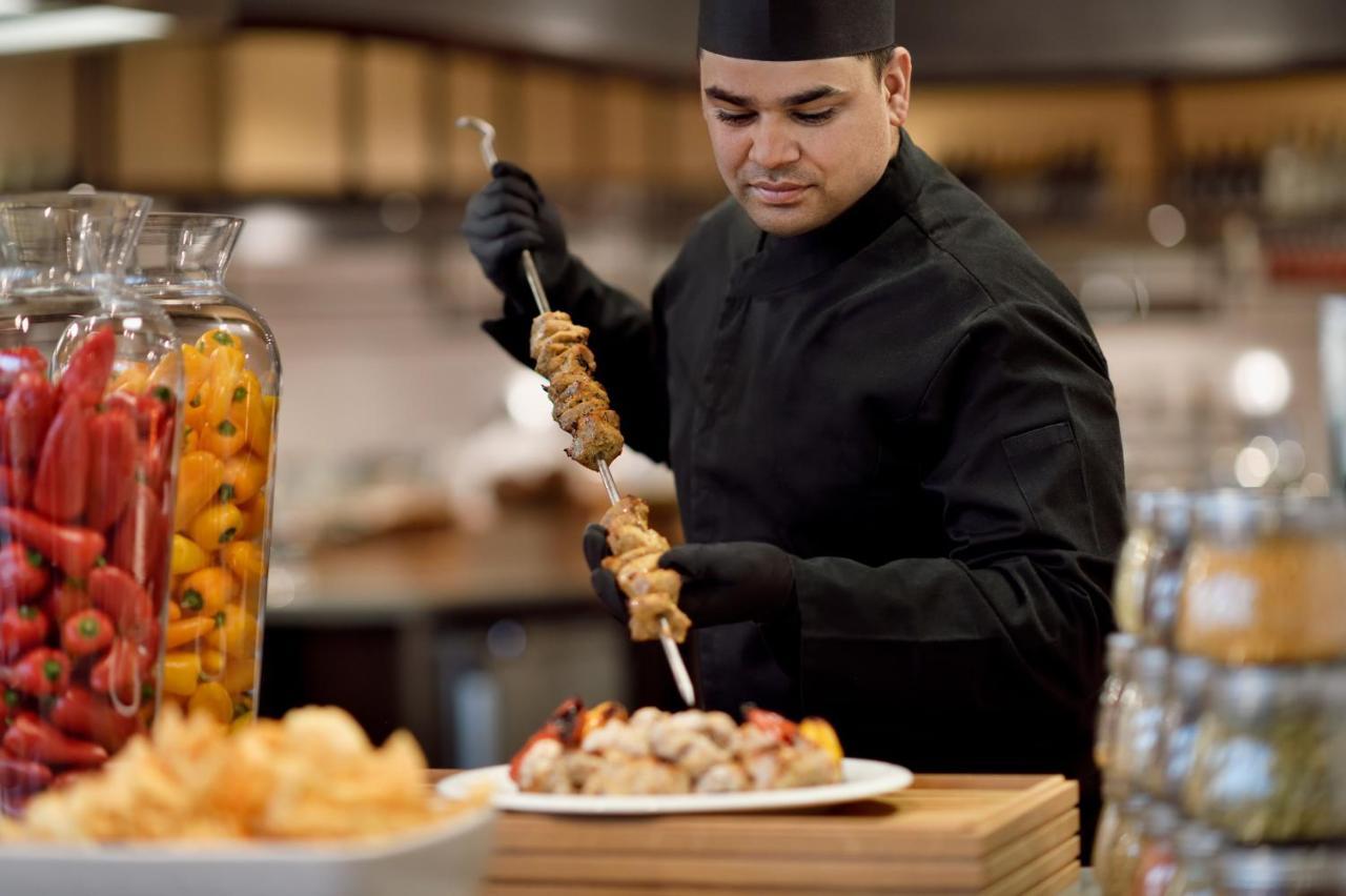 오피서 클럽 앤 호텔 아부다비 외부 사진 A chef preparing food